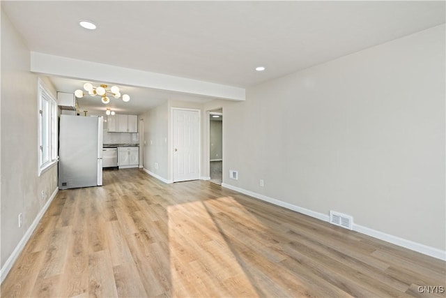 124 Aurora St, Rochester, NY 14621 - unfurnished living room with light wood-style floors, baseboards, recessed lighting, and a chandelier