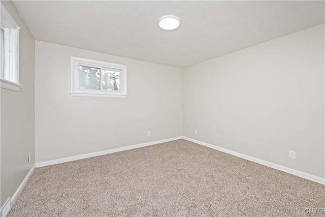124 Aurora St, Rochester, NY 14621 - carpeted empty room with baseboards