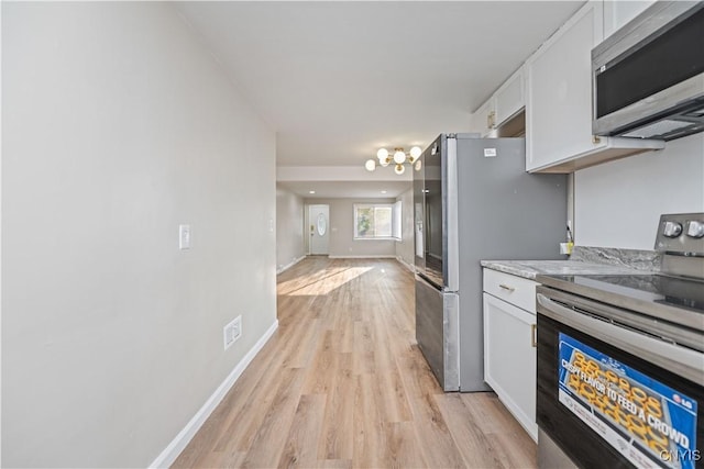 124 Aurora St, Rochester, NY 14621 - kitchen featuring stainless steel appliances, white cabinetry, light wood finished floors, and baseboards