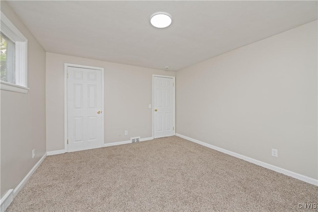 124 Aurora St, Rochester, NY 14621 - unfurnished bedroom with carpet and baseboards