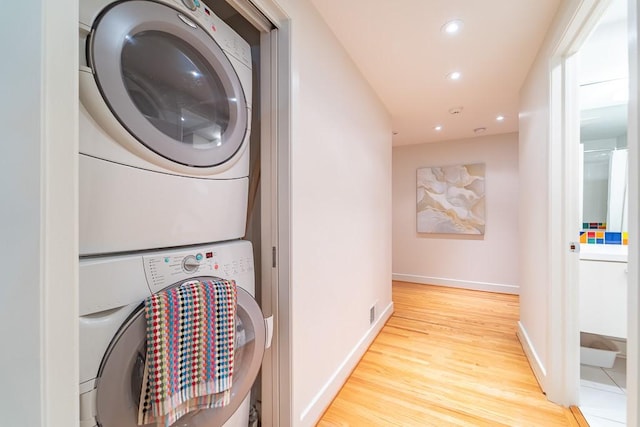 313 Pelham Rd, Brighton, NY 14610 - washroom featuring stacked washer and clothes dryer, wood finished floors, recessed lighting, and baseboards