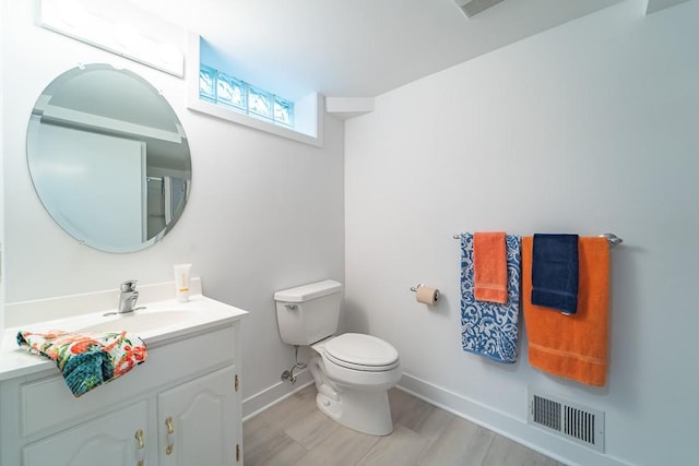 313 Pelham Rd, Brighton, NY 14610 - bathroom with vanity, baseboards, toilet, and wood finished floors