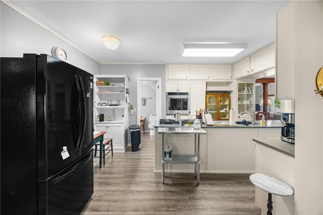 15205 W Lake Rd, Pulteney, NY 14418 - kitchen with stainless steel appliances, light wood-style flooring, crown molding, a peninsula, and dark countertops