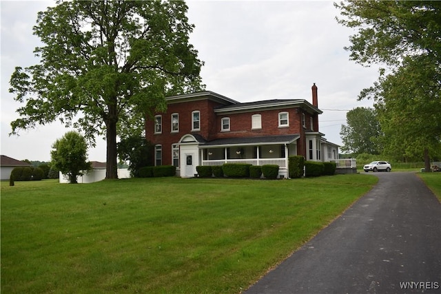 4571 Budd Rd, Cambria, NY 14094 - view of front of property featuring a porch, a chimney, and a front yard