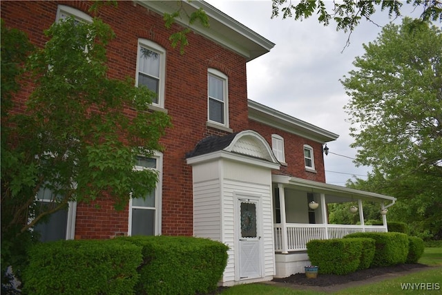 4571 Budd Rd, Cambria, NY 14094 - view of front facade with covered porch and brick siding
