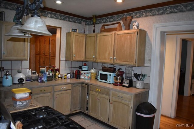 4571 Budd Rd, Cambria, NY 14094 - kitchen featuring white microwave, wallpapered walls, light countertops, and decorative backsplash