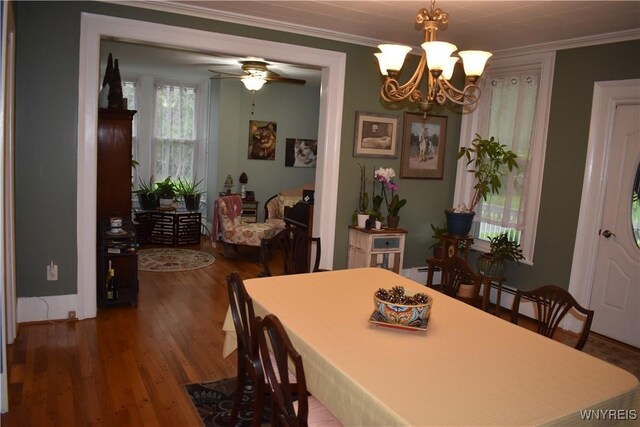 4571 Budd Rd, Cambria, NY 14094 - dining space with a chandelier, wood finished floors, crown molding, a ceiling fan, and a baseboard heating unit