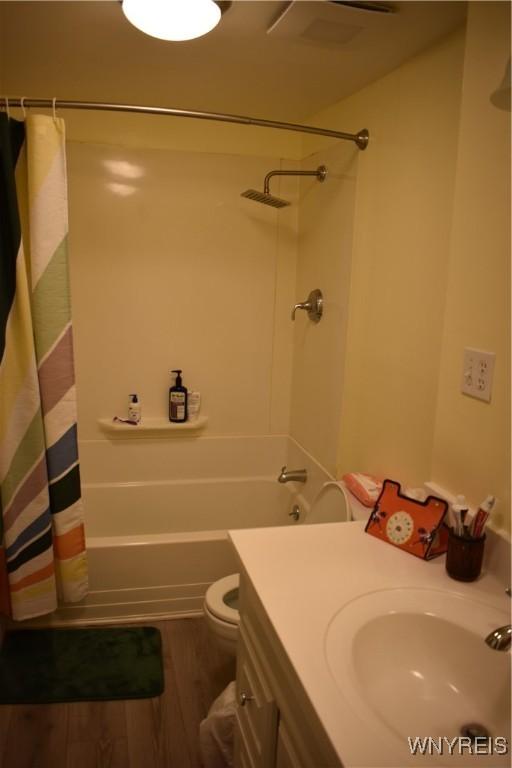 4571 Budd Rd, Cambria, NY 14094 - bathroom featuring shower / bath combo with shower curtain, vanity, wood finished floors, and toilet