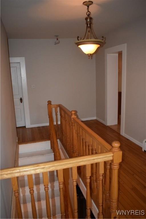 4571 Budd Rd, Cambria, NY 14094 - stairs featuring wood finished floors and baseboards
