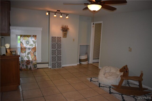 4571 Budd Rd, Cambria, NY 14094 - interior space with ceiling fan, a baseboard heating unit, tile patterned flooring, a baseboard radiator, and baseboards