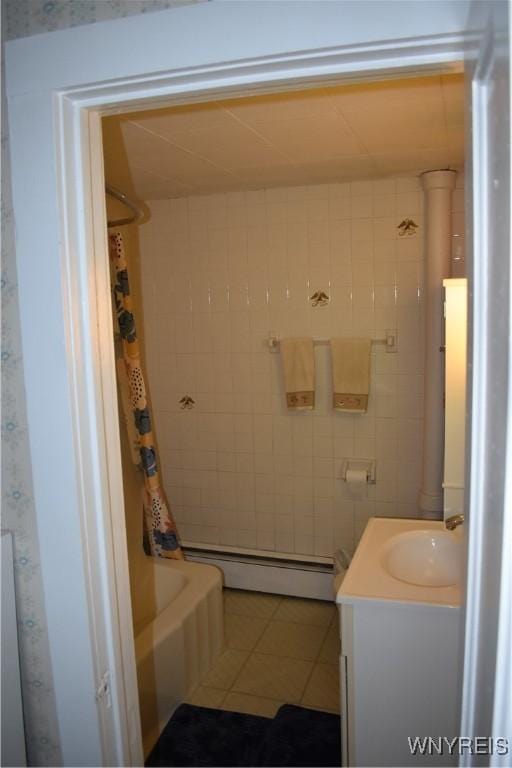 4571 Budd Rd, Cambria, NY 14094 - full bathroom with a baseboard radiator, tile patterned floors, vanity, and shower / bath combo