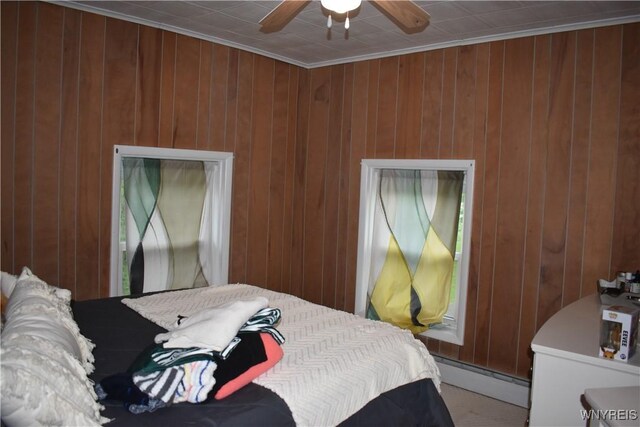 4571 Budd Rd, Cambria, NY 14094 - bedroom featuring a baseboard radiator, ornamental molding, wood walls, and a ceiling fan