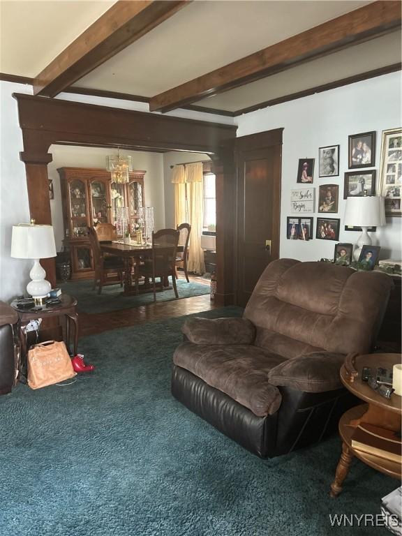 89 Rutland St, Buffalo, NY 14220 - carpeted living room with a chandelier and beam ceiling