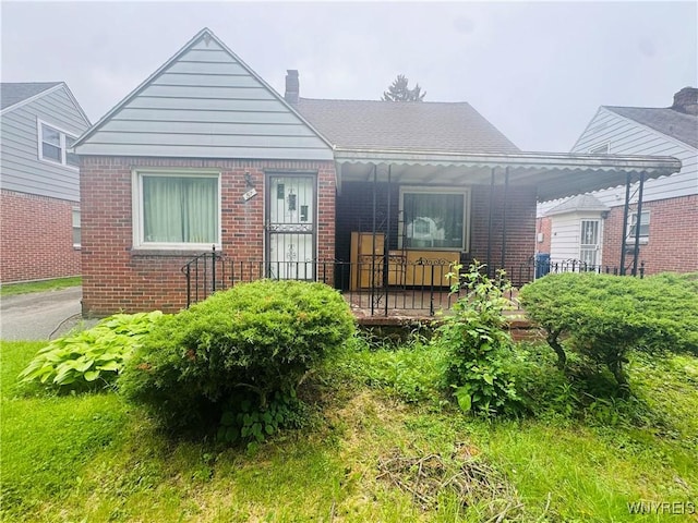 57 Erskine Ave, Buffalo, NY 14215 - bungalow-style house with brick siding, a chimney, and covered porch