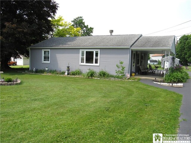 23 Frew Run St, Carroll, NY 14738 - rear view of house with a yard and roof with shingles