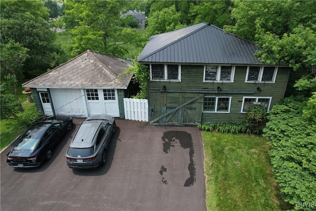 4937 W Seneca, Onondaga, NY 13215 - view of front of home with driveway, metal roof, and a garage