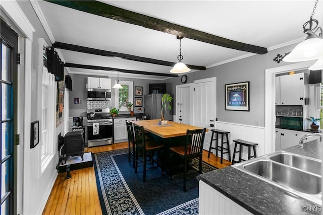 4937 W Seneca, Onondaga, NY 13215 - dining space with hardwood / wood-style floors, crown molding, beam ceiling, and wainscoting