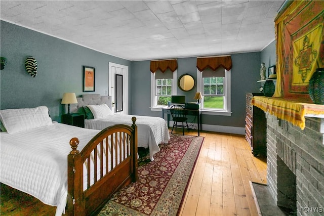 4937 W Seneca, Onondaga, NY 13215 - bedroom with a fireplace, light wood finished floors, and baseboards