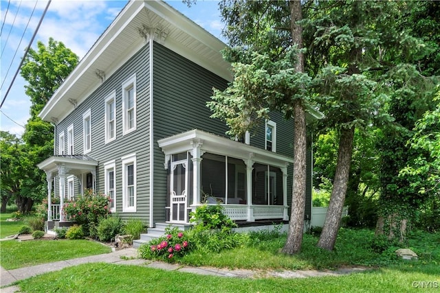 4937 W Seneca, Onondaga, NY 13215 - view of home's exterior featuring a sunroom and a lawn