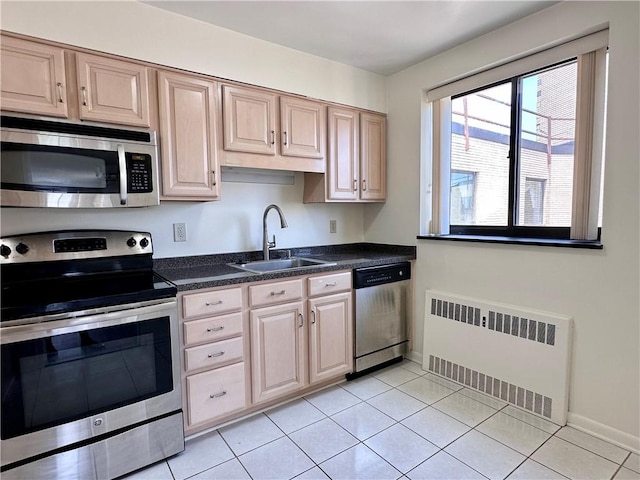 2501 E Ave, Brighton, NY 14610 - kitchen featuring stainless steel appliances, radiator heating unit, a sink, dark countertops, and light tile patterned flooring