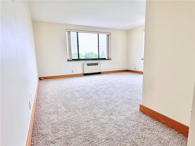 2501 E Ave, Brighton, NY 14610 - carpeted empty room featuring radiator and baseboards