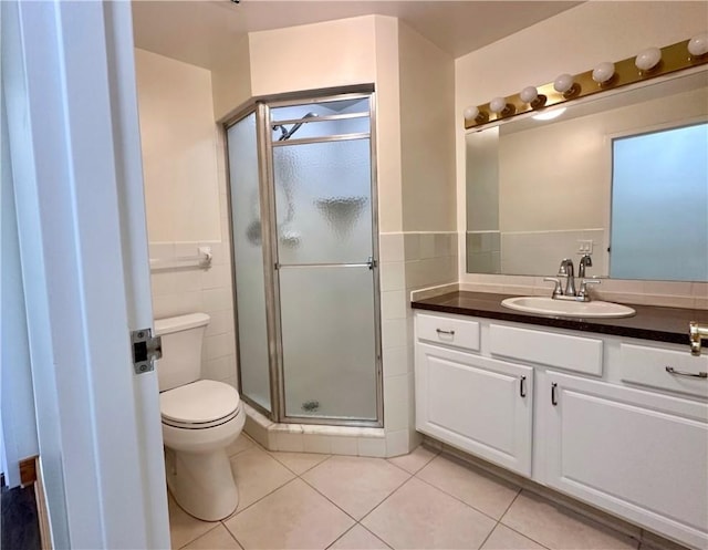 2501 E Ave, Brighton, NY 14610 - bathroom with tile walls, tile patterned flooring, a shower stall, vanity, and toilet