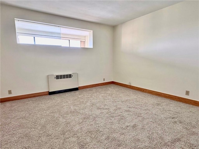 2501 E Ave, Brighton, NY 14610 - empty room with carpet flooring, radiator heating unit, and baseboards