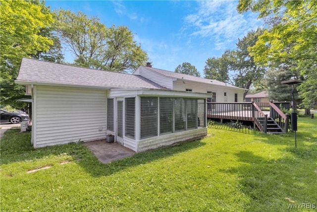 1701 Billington Rd, Elma, NY 14052 - back of property featuring a sunroom, a wooden deck, a lawn, and roof with shingles