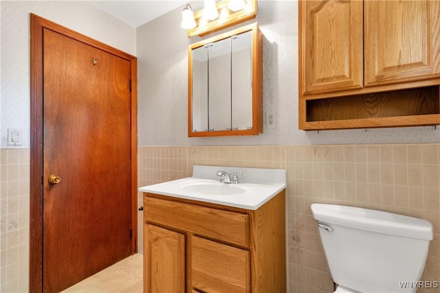 1701 Billington Rd, Elma, NY 14052 - bathroom with vanity, tile walls, toilet, and wainscoting