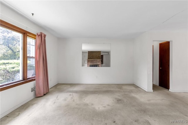1701 Billington Rd, Elma, NY 14052 - empty room with a brick fireplace, carpet flooring, and baseboards
