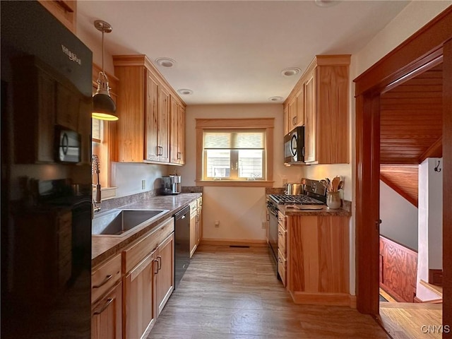 700 Elm St, Rome-Inside, NY 13440 - kitchen featuring gas range oven, black microwave, dishwashing machine, baseboards, and light wood finished floors