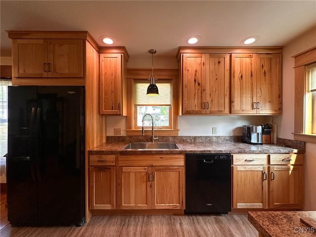 700 Elm St, Rome-Inside, NY 13440 - kitchen with black appliances, a sink, light wood-type flooring, dark countertops, and decorative light fixtures