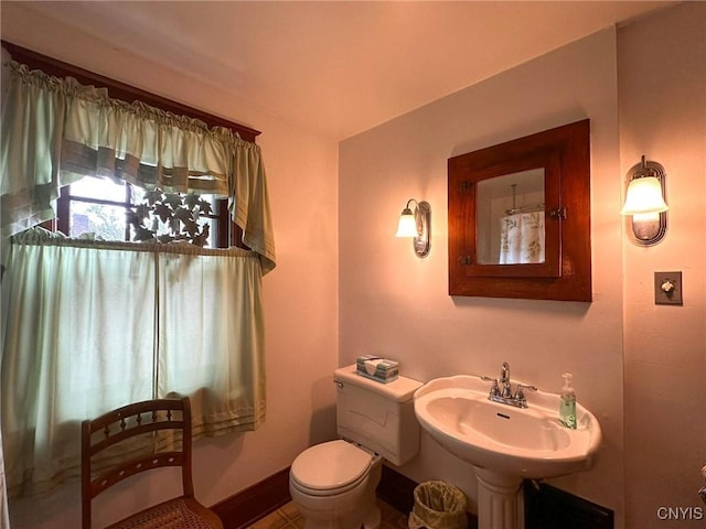 700 Elm St, Rome-Inside, NY 13440 - half bathroom with toilet, baseboards, and a sink