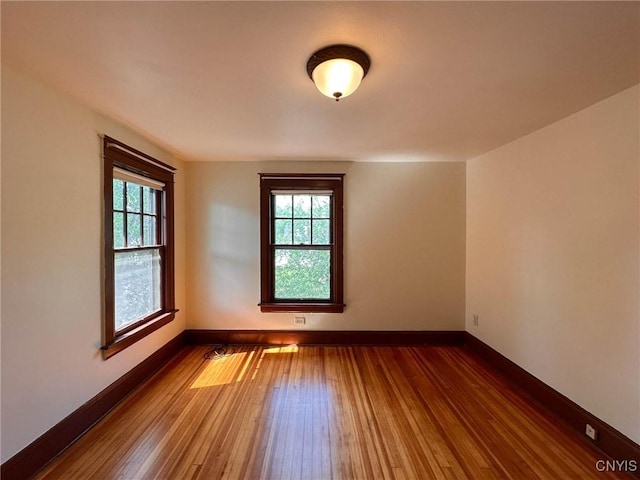 700 Elm St, Rome-Inside, NY 13440 - unfurnished room featuring wood-type flooring, healthy amount of natural light, and baseboards