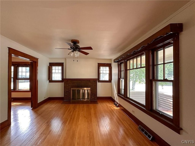 700 Elm St, Rome-Inside, NY 13440 - unfurnished living room featuring baseboards, a ceiling fan, light wood-type flooring, and a fireplace