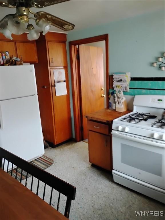 72 Nicholson St, Buffalo, NY 14214 - kitchen featuring white appliances, a ceiling fan, and brown cabinetry