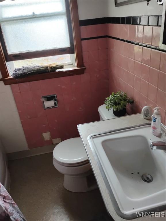 72 Nicholson St, Buffalo, NY 14214 - bathroom with toilet and tile walls