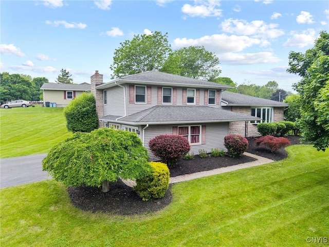 311 Mcintosh Dr, Auburn, NY 13021 - view of front of house with a chimney and a front yard