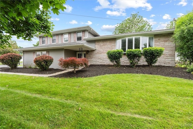 311 Mcintosh Dr, Auburn, NY 13021 - view of front of house featuring stone siding and a front yard