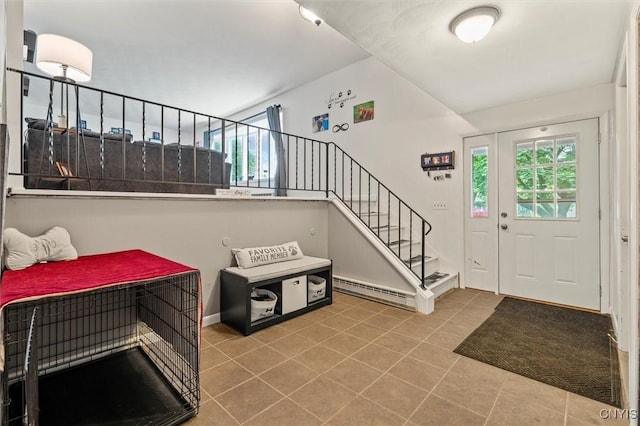311 Mcintosh Dr, Auburn, NY 13021 - tiled entrance foyer with stairs, a baseboard radiator, and baseboards