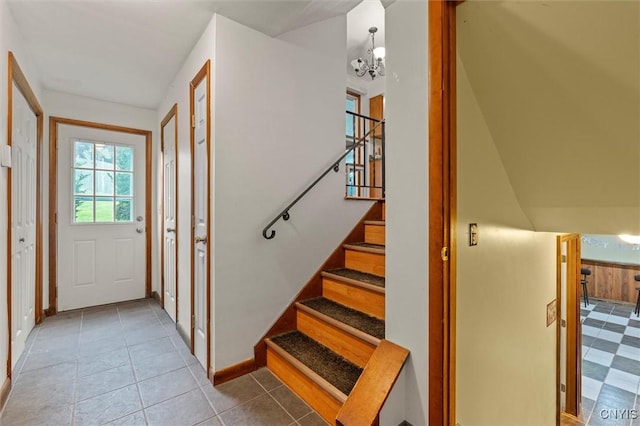 311 Mcintosh Dr, Auburn, NY 13021 - foyer entrance with stairs, a chandelier, and tile patterned flooring