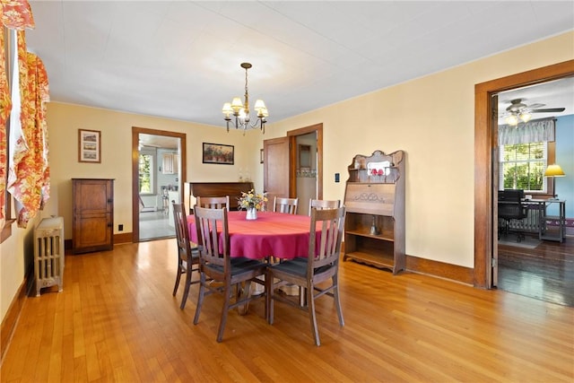 707 Hubbell Rd, Ogden, NY 14428 - dining space with radiator heating unit, plenty of natural light, light wood-style floors, and a chandelier