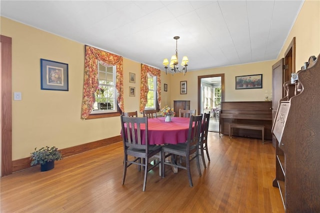 707 Hubbell Rd, Ogden, NY 14428 - dining space featuring a chandelier, plenty of natural light, light wood-style flooring, and baseboards