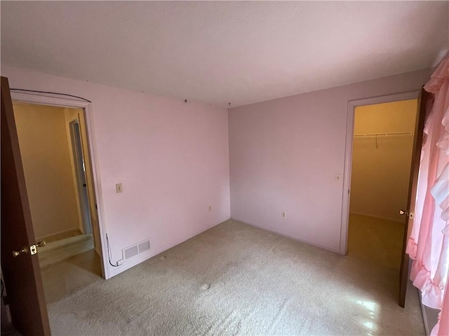 235 Briarwood Ln, Wheatland, NY 14546 - unfurnished bedroom with carpet, a spacious closet, and a closet