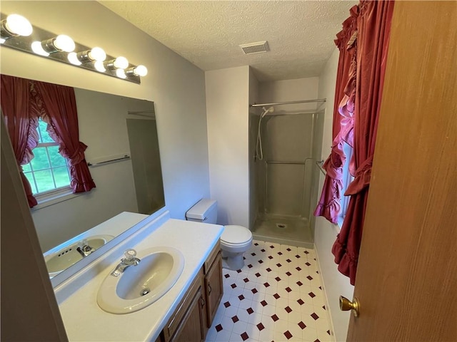 235 Briarwood Ln, Wheatland, NY 14546 - full bathroom featuring a shower, vanity, toilet, a textured ceiling, and tile patterned floors
