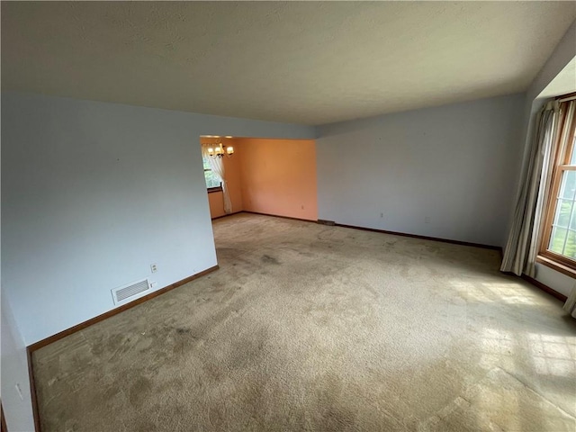 235 Briarwood Ln, Wheatland, NY 14546 - empty room with light colored carpet, a chandelier, and baseboards