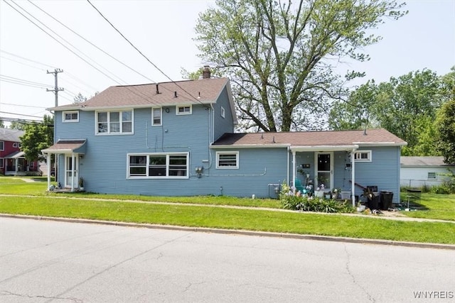 596 Longmeadow Rd, Amherst, NY 14226 - rear view of property with a chimney and a yard