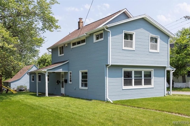 596 Longmeadow Rd, Amherst, NY 14226 - rear view of property featuring a chimney and a lawn