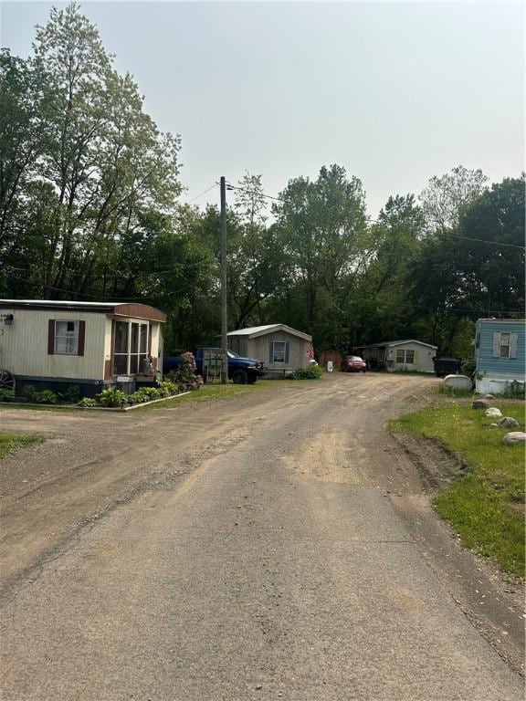28 Main St, Unadilla, NY 13849 - view of front of property with driveway and view of wooded area