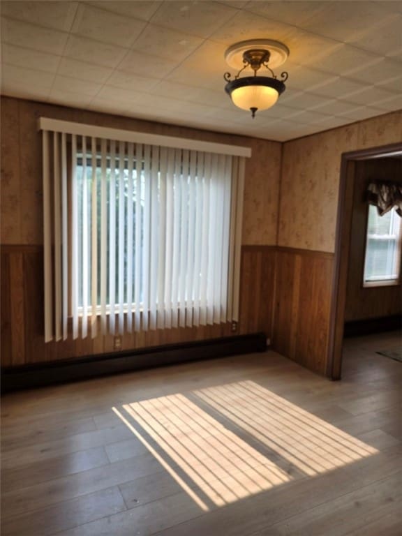 30 Park Ave, Eldred, PA 16731 - unfurnished room with a wainscoted wall, hardwood / wood-style flooring, and wood walls